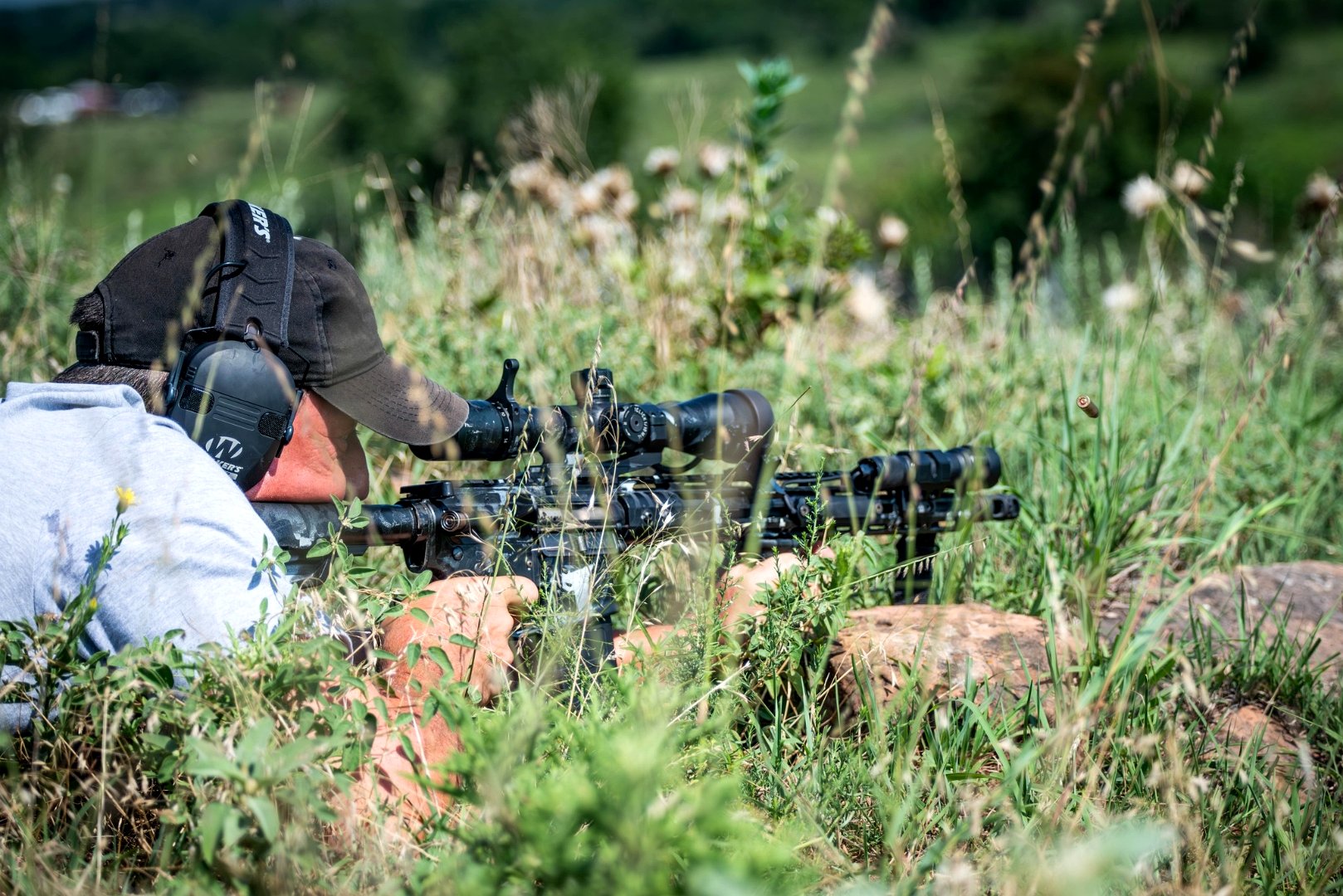 Rifle shooting in grass