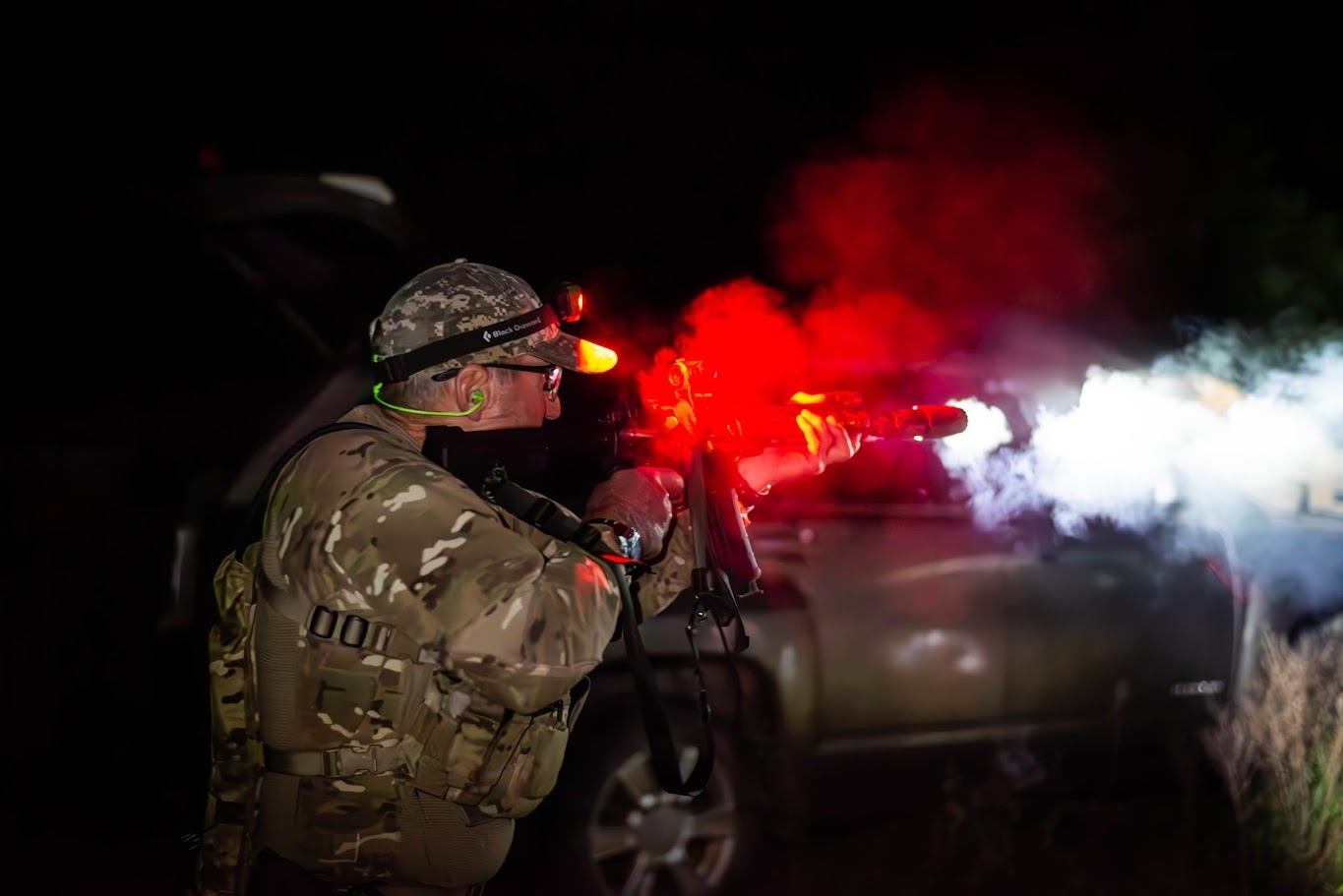 Night operations — competitor firing under low light at The Burial Mound